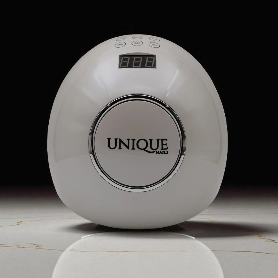 Unique Nails luxe UV LED nagellamp voor gelnagels – witte professionele nageldroger op marmeren ondergrond